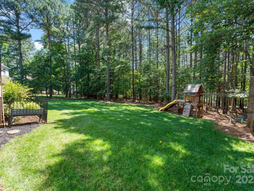 347 Bayberry Creek Circle, Mooresville, NC 28117.  MLS# CAR4271550, YatesRealty ID 21074. Tree lined backyard