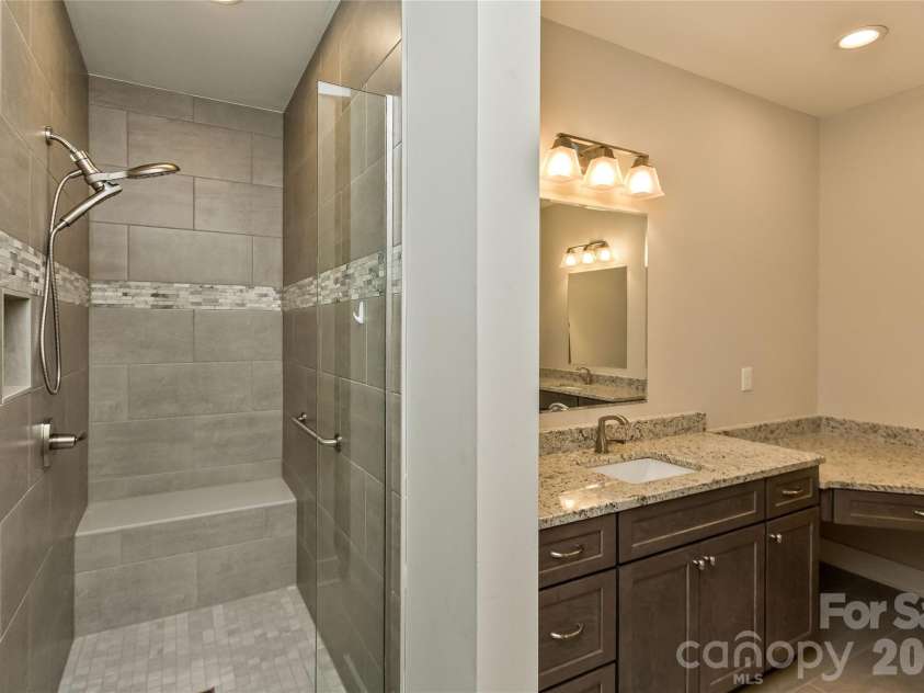 96 Copper Valley Lane, Hendersonville, NC 28739.  MLS# CAR4376477, YatesRealty ID 21094. Spacious Walk-in Shower with a Tile Bench