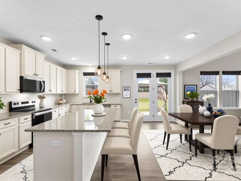 858 Oak Manor Drive, Concord, NC 28025.  MLS# CAR4332430, YatesRealty ID 21121. Kitchen and dining area virtually staged