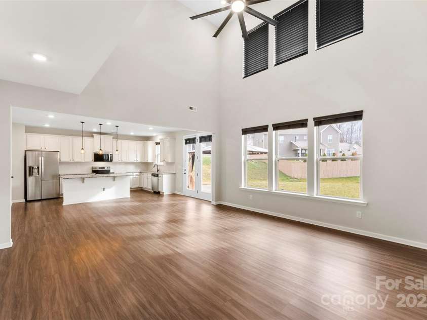 858 Oak Manor Drive, Concord, NC 28025.  MLS# CAR4332430, YatesRealty ID 21121. Living room and dining area. Lots of space for a full living room set and dining table!