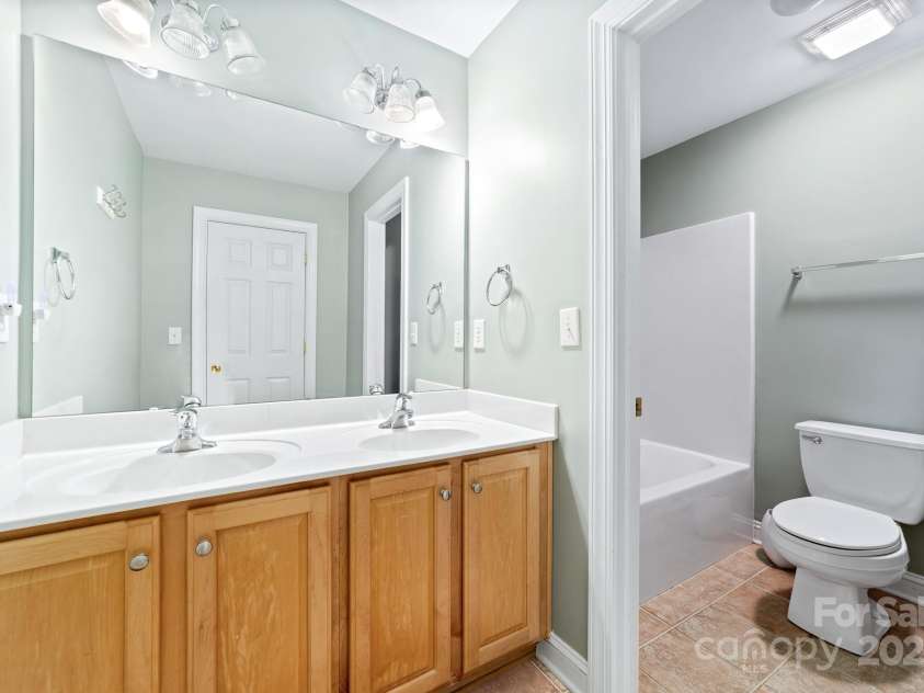 12002 Cobham Court, Huntersville, NC 28078.  MLS# CAR4269076, YatesRealty ID 21134. Upper full bath with door separating sinks and tub/shower/toilet