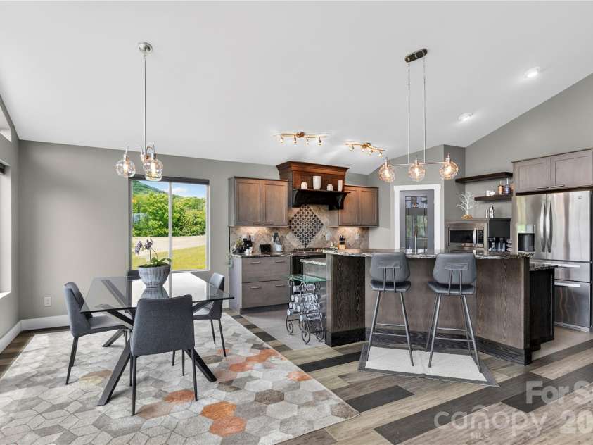 141 Round Top Circle, Mills River, NC 28759.  MLS# CAR4379751, YatesRealty ID 21136. The open kitchen layout provides a comfortable dining area and dedicated space for bar stools, ideal for casual meals and entertaining.