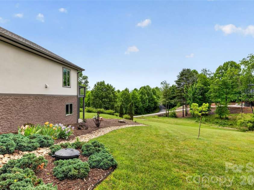 141 Round Top Circle, Mills River, NC 28759.  MLS# CAR4379751, YatesRealty ID 21136. Thoughtfully designed dry creek bed provides attractive, functional drainage.