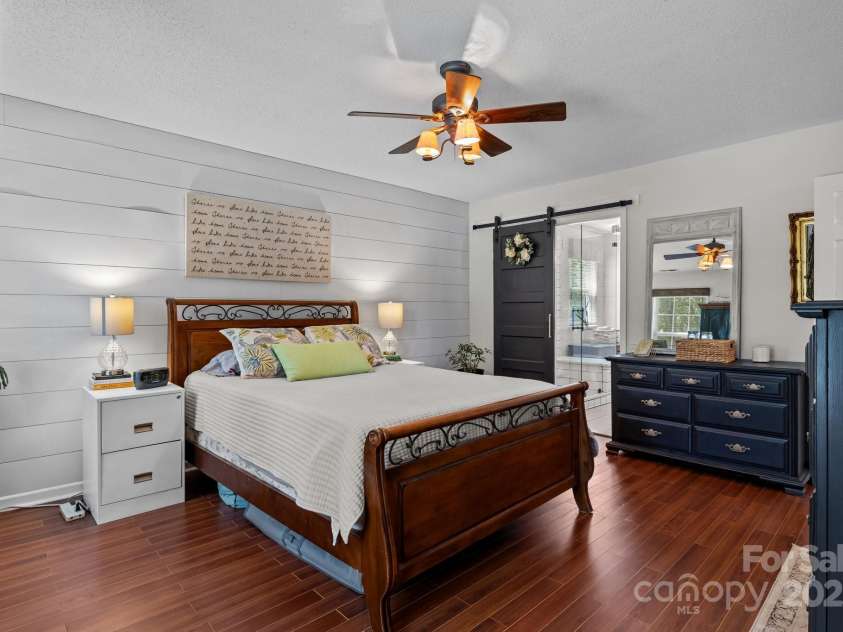 8700 Fox Tail Lane, Huntersville, NC 28078.  MLS# CAR4269110, YatesRealty ID 21136. Adding a modern farmhouse touch, a sliding barn door leads to the en-suite bathroom.
