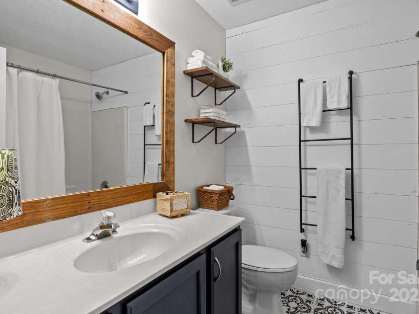 8700 Fox Tail Lane, Huntersville, NC 28078.  MLS# CAR4269110, YatesRealty ID 21136. Full bath features ceramic tile flooring, a large mirror above the vanity enhances the sense of space and light. Just across the hall, a spacious linen closet provides convenient storage for towels, toiletries , and 