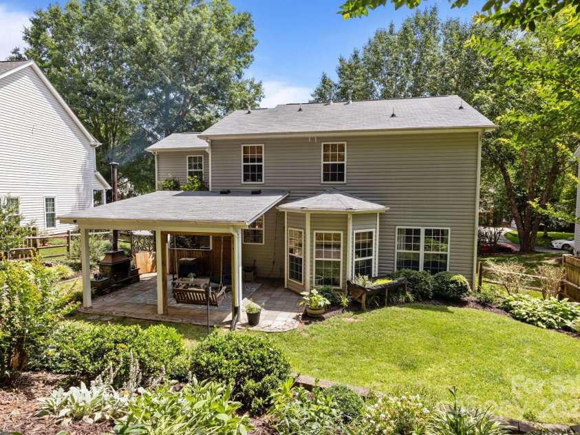 8700 Fox Tail Lane, Huntersville, NC 28078.  MLS# CAR4269110, YatesRealty ID 21136. Mature trees and stunning landscaping create a serene and picturesque setting.