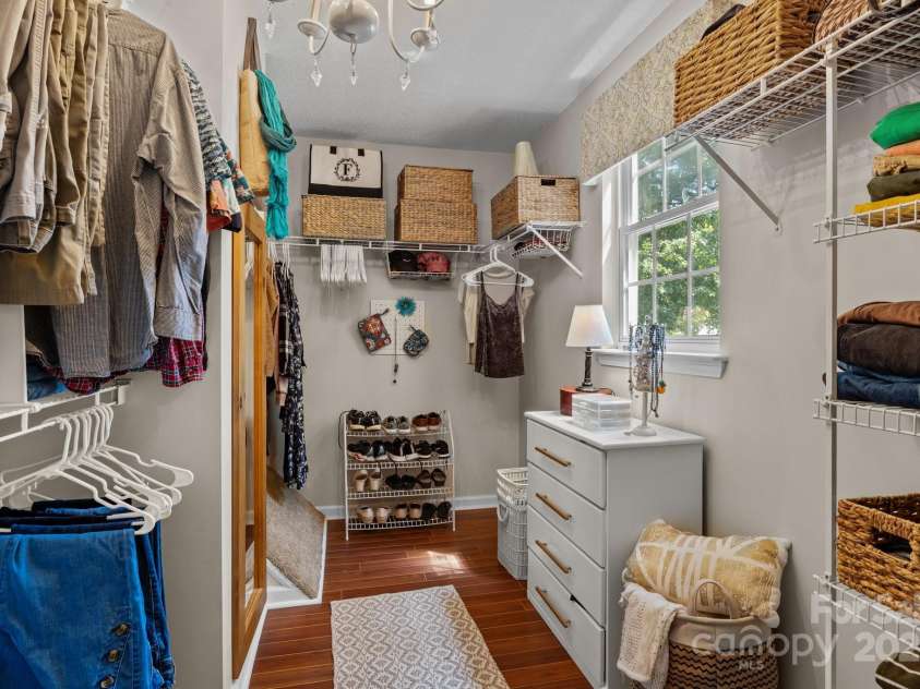 8700 Fox Tail Lane, Huntersville, NC 28078.  MLS# CAR4269110, YatesRealty ID 21136. Spacious walk-in closet w/Pergo flooring adding a warm polished look. Designed for maximum organization, the closet features extensive wire shelving to accomadate clothing, shoes and accessories with ease. A window b