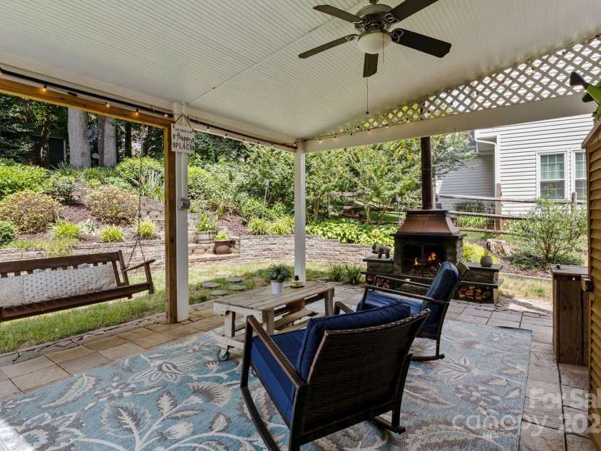 8700 Fox Tail Lane, Huntersville, NC 28078.  MLS# CAR4269110, YatesRealty ID 21136. Step outside from the breakfast room and kitchen into a stunning 15x21 covered patio designed for year-round enjoyment - an ideal extension of your living space. The patio features rich slate pavers, offering both du