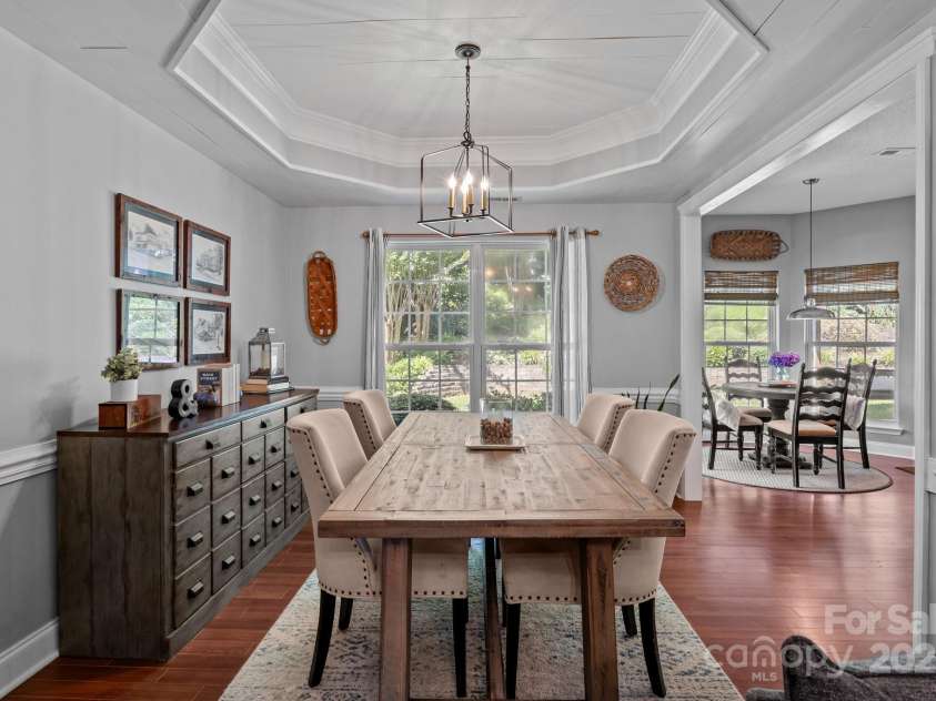 8700 Fox Tail Lane, Huntersville, NC 28078.  MLS# CAR4269110, YatesRealty ID 21136. The dining room flows seamlessly from the living area. Durable Pergo floors continue throughout, providing durability and warmth underfoot. Perfect for special gatherings!
