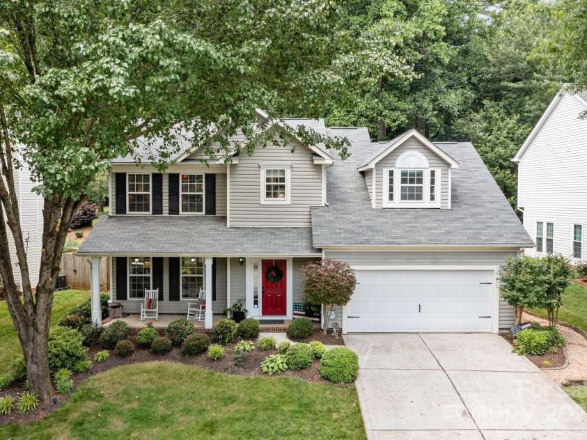 8700 Fox Tail Lane, Huntersville, NC 28078.  MLS# CAR4269110, YatesRealty ID 21136. The inviting covered front porch offers the perfect spot to relax and enjoy the beauty of the surroundings.