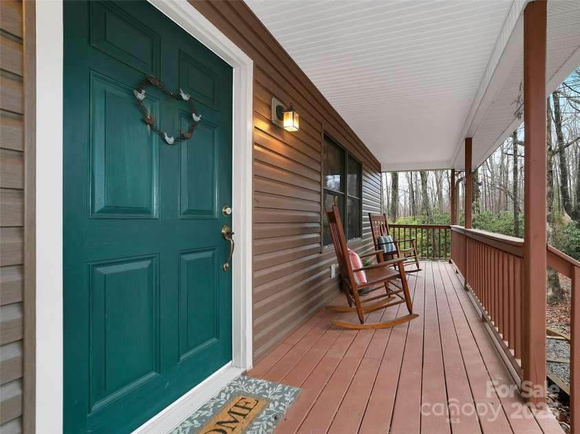 144 Panther Gap Road, Brevard, NC 28712.  MLS# CAR4240689, YatesRealty ID 21141. Covered front rocking chair porch