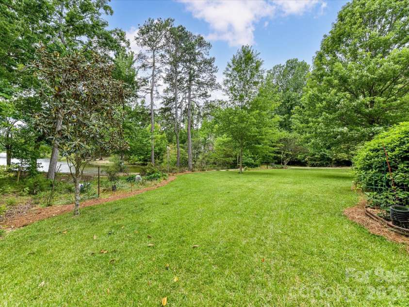 2007 Sugar Mill Road, Indian Trail, NC 28079.  MLS# CAR4375322, YatesRealty ID 21143. Backyard with view of the pond