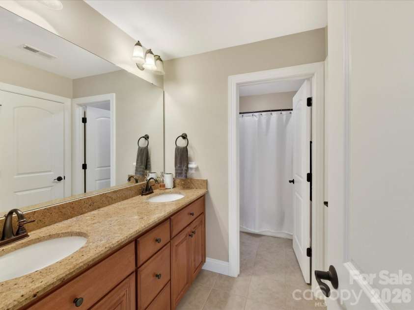 2007 Sugar Mill Road, Indian Trail, NC 28079.  MLS# CAR4375322, YatesRealty ID 21143. Guest bath with double sink vanity, shower tub combo - shares with all access