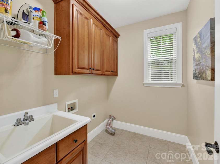 2007 Sugar Mill Road, Indian Trail, NC 28079.  MLS# CAR4375322, YatesRealty ID 21143. Main level laundry room with utility sink