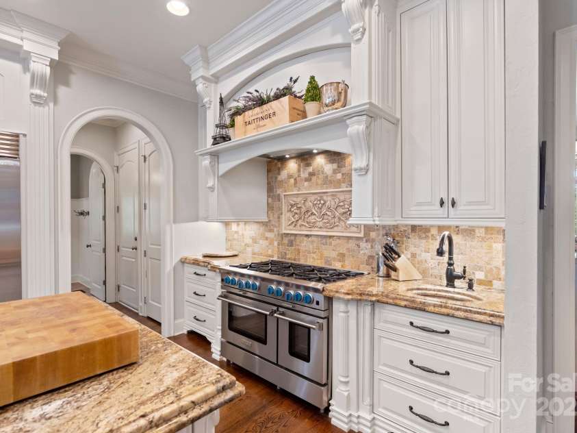 167 Quaker Road, Mooresville, NC 28117.  MLS# CAR4261192, YatesRealty ID 21144. Decorative hidden spice racks surrounding industrial size gas range