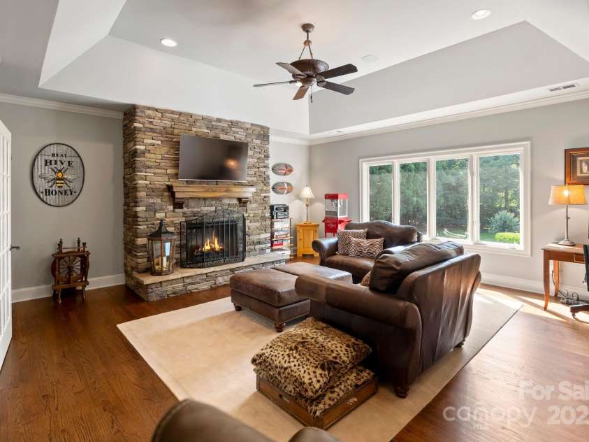 167 Quaker Road, Mooresville, NC 28117.  MLS# CAR4261192, YatesRealty ID 21144. Game room with French door entry and electric fieldstone fireplace, also offers 6th fairway view