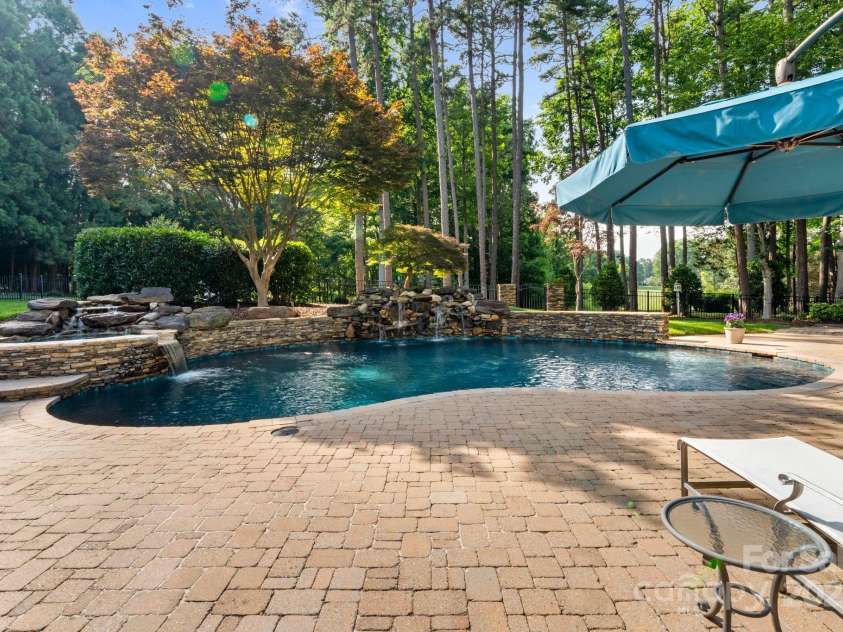 167 Quaker Road, Mooresville, NC 28117.  MLS# CAR4261192, YatesRealty ID 21144. In-ground heated saltwater pool and spa with waterfall