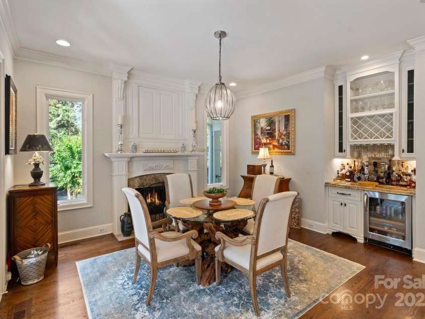 167 Quaker Road, Mooresville, NC 28117.  MLS# CAR4261192, YatesRealty ID 21144. Keeping room features gas fireplace and bar area with beverage fridge.