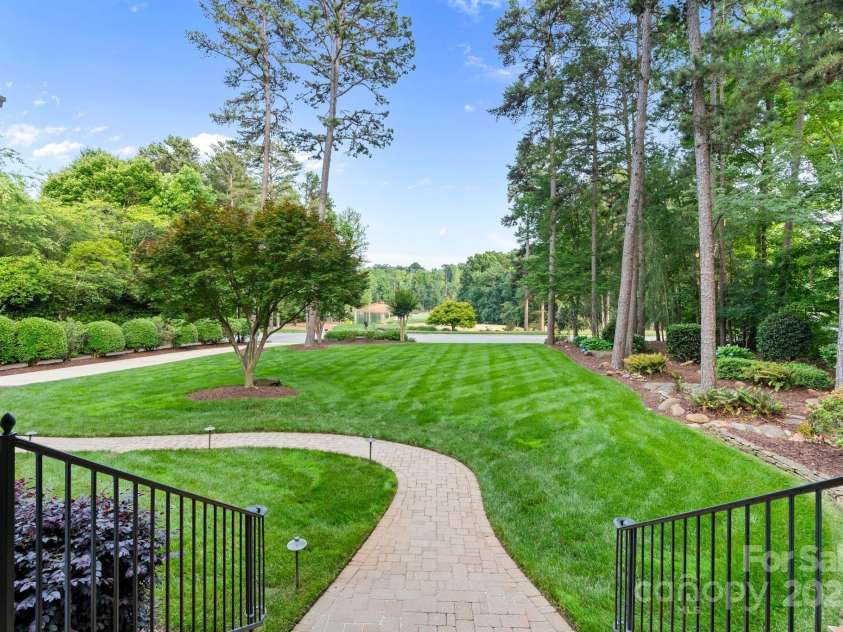 167 Quaker Road, Mooresville, NC 28117.  MLS# CAR4261192, YatesRealty ID 21144. Lake and golf course views from the front porch