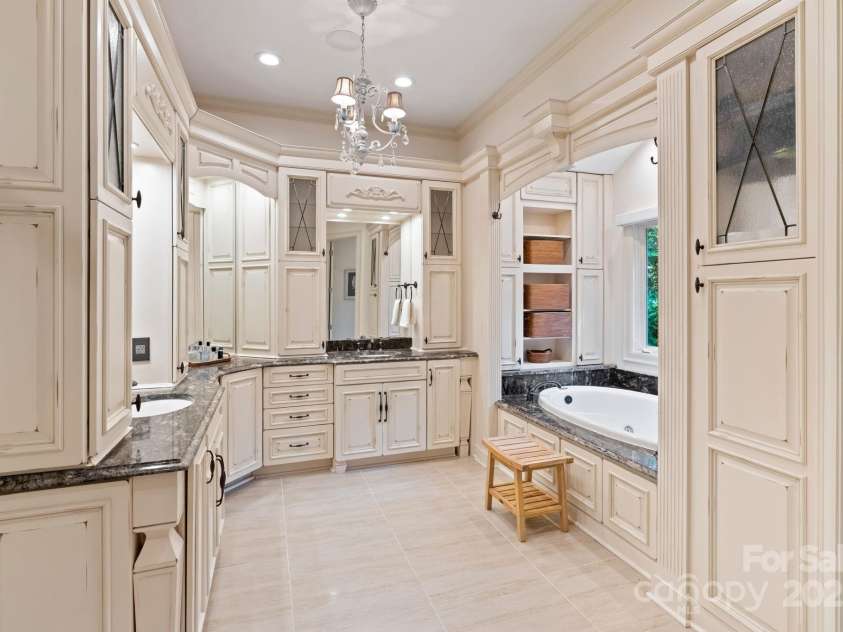 167 Quaker Road, Mooresville, NC 28117.  MLS# CAR4261192, YatesRealty ID 21144. Primary bathroom double vanity, his-and-her walk-in closets, and garden tub