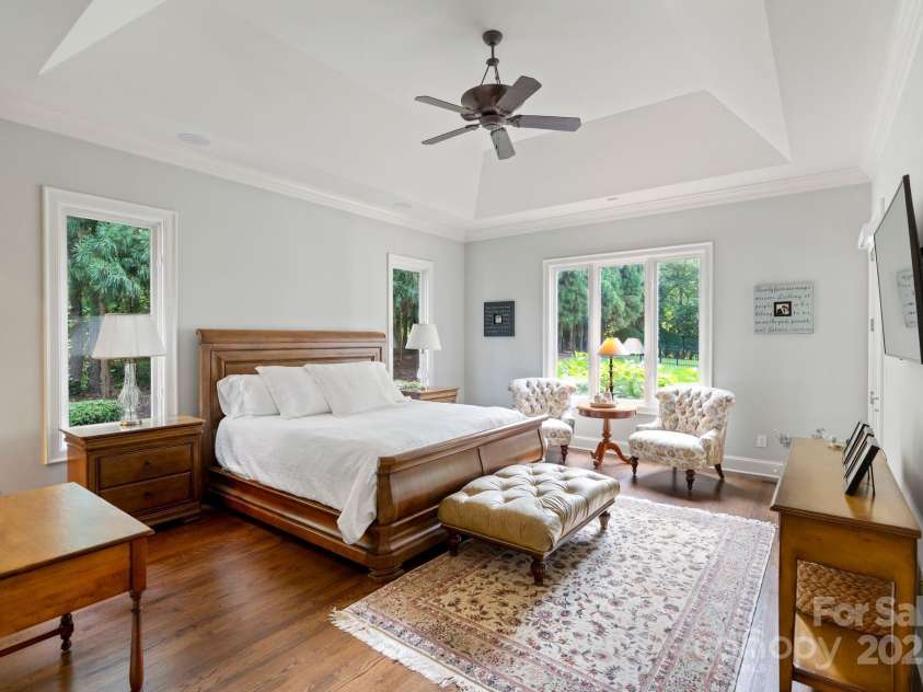 167 Quaker Road, Mooresville, NC 28117.  MLS# CAR4261192, YatesRealty ID 21144. Spacious primary bedroom on main offering deck access.