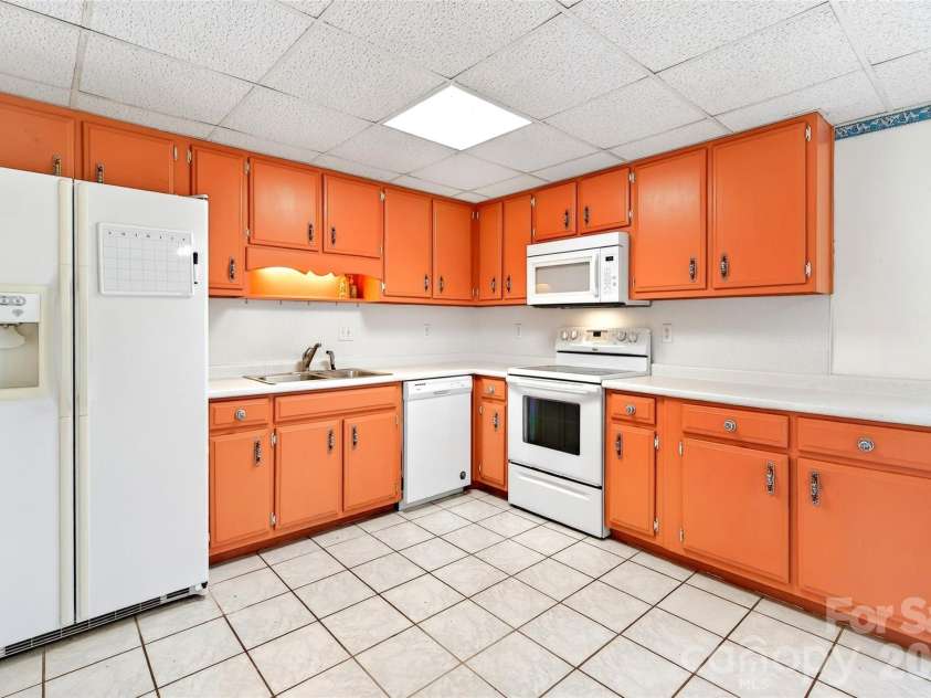 75 Laurelwood Drive, Marion, NC 28752.  MLS# CAR4361973, YatesRealty ID 21144. Ample wooden cabinets offer plenty of storage.