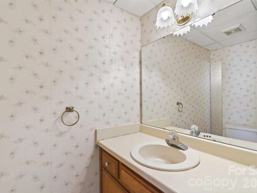 75 Laurelwood Drive, Marion, NC 28752.  MLS# CAR4361973, YatesRealty ID 21144. Half bath off the living and kitchen area.