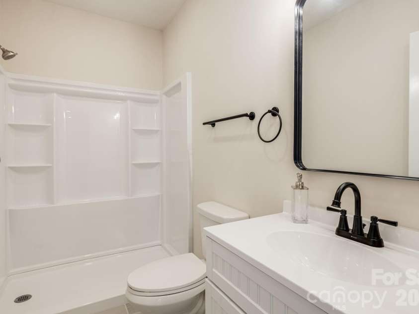 17 Baxter Woods Lane, Candler, NC 28715.  MLS# CAR4370990, YatesRealty ID 21147. Lower level Bathroom