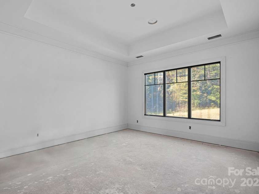 5039 Eliza Long Wilkie Drive, Huntersville, NC 28078.  MLS# CAR4240694, YatesRealty ID 21152. Primary Bedroom with tray ceiling and door to covered/screened outdoor living