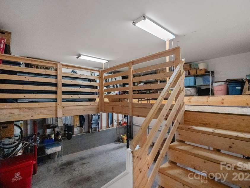 202 Caldwell Lane, Davidson, NC 28036.  MLS# CAR4269937, YatesRealty ID 21169. Custom built-in storage/workspace in garage with stair access from house