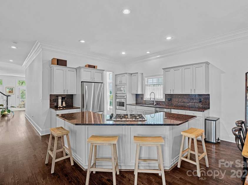 202 Caldwell Lane, Davidson, NC 28036.  MLS# CAR4269937, YatesRealty ID 21169. Gourmet kitchen with large island, granite countertops and separate dining area