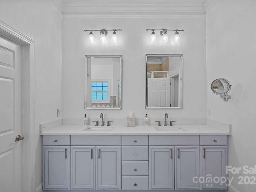 202 Caldwell Lane, Davidson, NC 28036.  MLS# CAR4269937, YatesRealty ID 21169. Primary bathroom with dual vanities and quartz countertop
