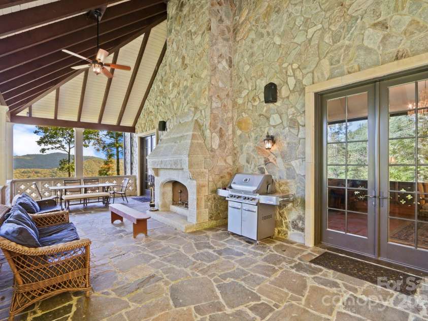 5742 NC Highway 194 None, Banner Elk, NC 28604.  MLS# CAR4309269, YatesRealty ID 2117. Patio off Great Room with antique stone fireplace