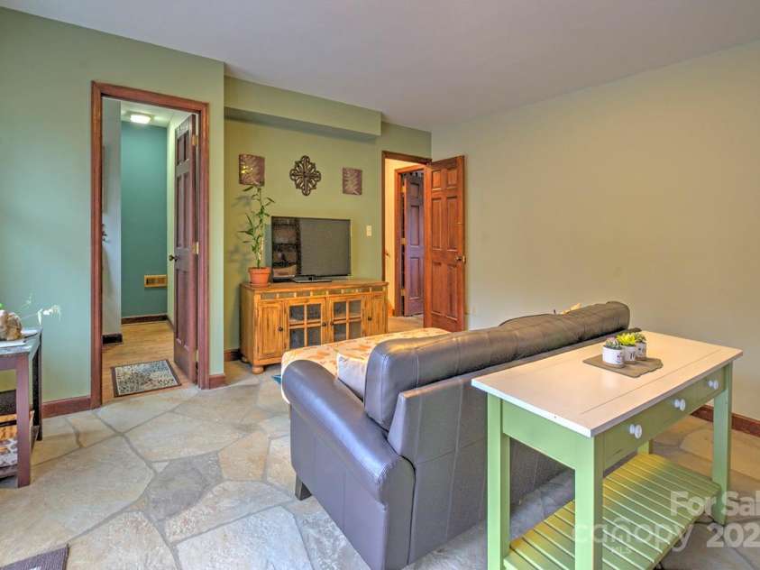 9374 Holbert Cove Road, Saluda, NC 28773.  MLS# CAR4227535, YatesRealty ID 2117. Family room 2