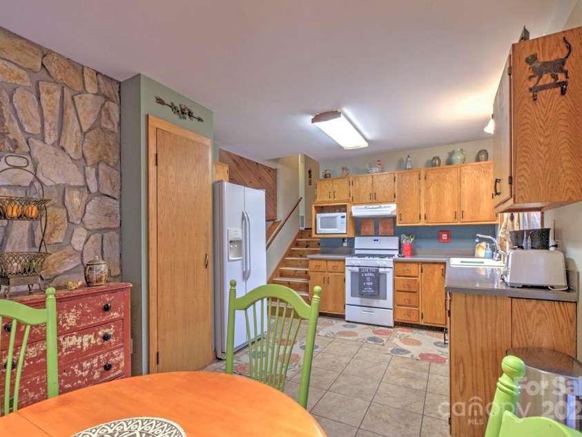 9374 Holbert Cove Road, Saluda, NC 28773.  MLS# CAR4227535, YatesRealty ID 2117. Kitchen from dining area