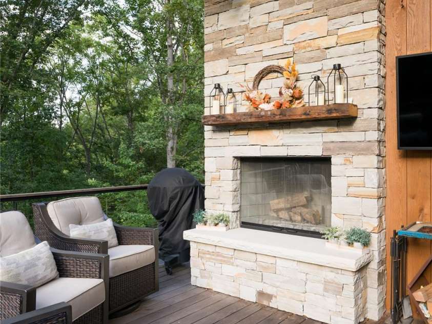13 Tulip Poplar Trail, Asheville, NC 28804.  MLS# CAR4352728, YatesRealty ID 21170. Outside stone fireplace on upper level deck
