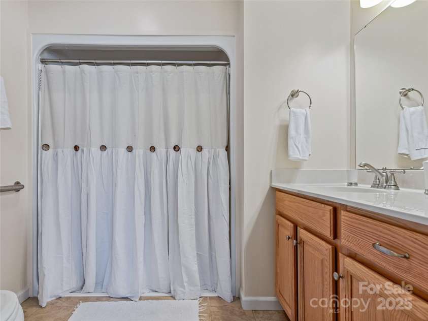 29 Robinhood Road, Asheville, NC 28804.  MLS# CAR4202474, YatesRealty ID 21176. Walk in shower in guest suite