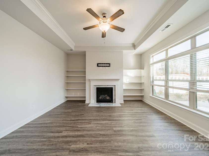 1005 Headwaters Court, Matthews, NC 28104.  MLS# CAR4233423, YatesRealty ID 21177. Family room with gas fireplace, trey ceilings and lots of natural light.