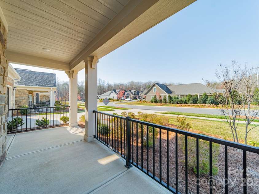 1005 Headwaters Court, Matthews, NC 28104.  MLS# CAR4233423, YatesRealty ID 21177. Rocking chair front porch