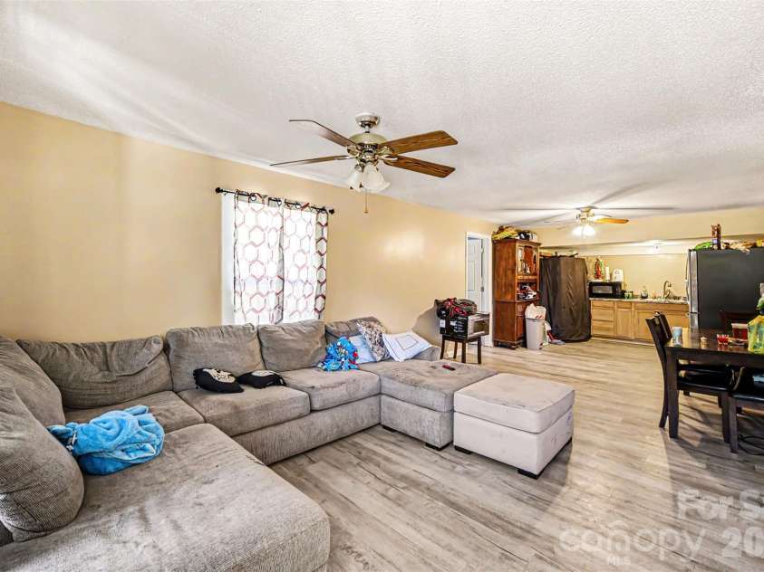 12 Bost Avenue, Concord, NC 28027.  MLS# CAR4381096, YatesRealty ID 2118. Living Room into dining and kitchen