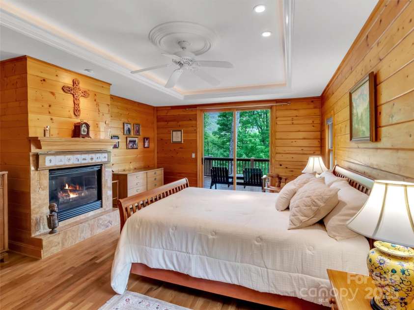 421 Ramp Patch Lane, Waynesville, NC 28786.  MLS# CAR4257466, YatesRealty ID 21184. Primary Bedroom with Fireplace & Porch Access