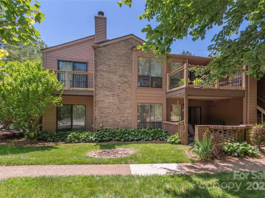 33 Ravencroft Lane, Asheville, NC 28803.  MLS# CAR4251539, YatesRealty ID 21199. Ground level view - primary bedroom on left & living area on right.