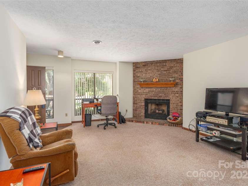 33 Ravencroft Lane, Asheville, NC 28803.  MLS# CAR4251539, YatesRealty ID 21199. Living area with gas fireplace