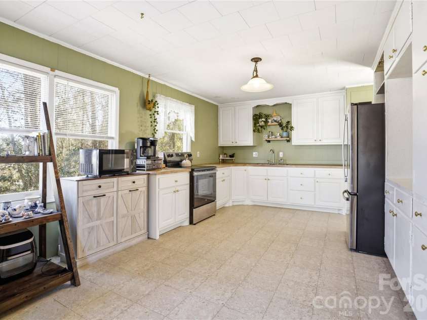 7775 Marlette Lane, Sherrills Ford, NC 28673.  MLS# CAR4341133, YatesRealty ID 2121. Fresh white cabinetry and resilient flooring create a crisp, functional kitchen.