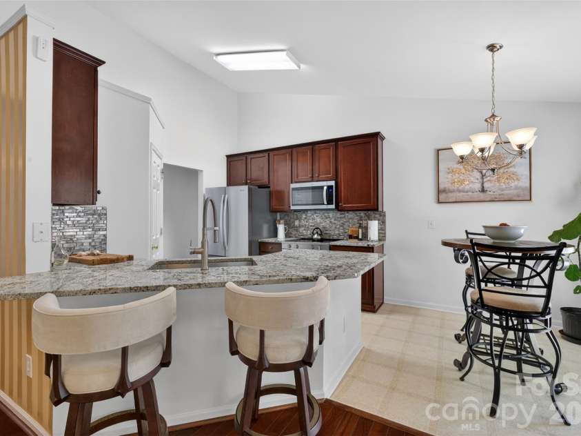 9095 Pembroke Court, Indian Land, SC 29707.  MLS# CAR4374675, YatesRealty ID 21221. Kitchen peninsula bar
