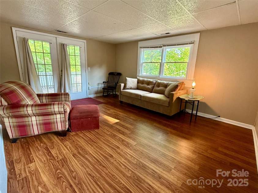 43 Howard Street, Tryon, NC 28782.  MLS# CAR4268057, YatesRealty ID 21234. Cottage living room - lots of windows & light!