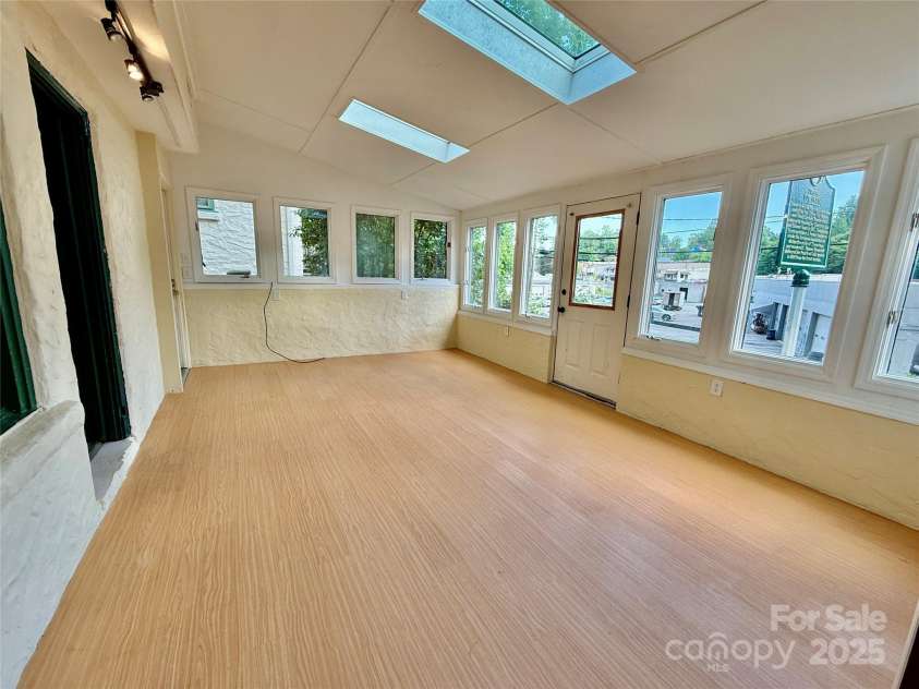 43 Howard Street, Tryon, NC 28782.  MLS# CAR4268057, YatesRealty ID 21234. Toy House bright living room with skylights