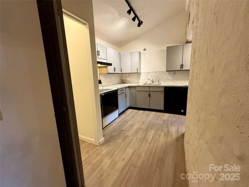 43 Howard Street, Tryon, NC 28782.  MLS# CAR4268057, YatesRealty ID 21234. Toy House kitchen with washer/dryer closet