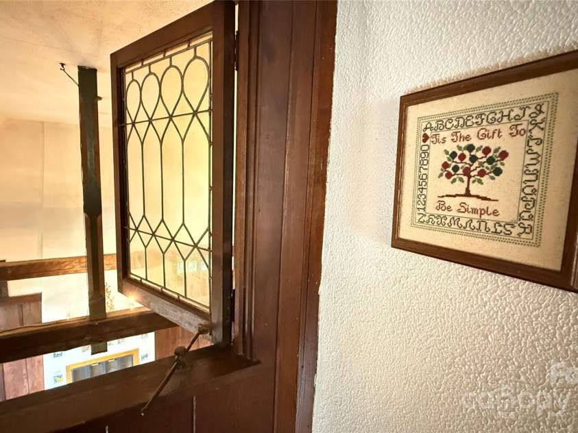 43 Howard Street, Tryon, NC 28782.  MLS# CAR4268057, YatesRealty ID 21234. Toy House loft window looks into large family room with vaulted ceiling