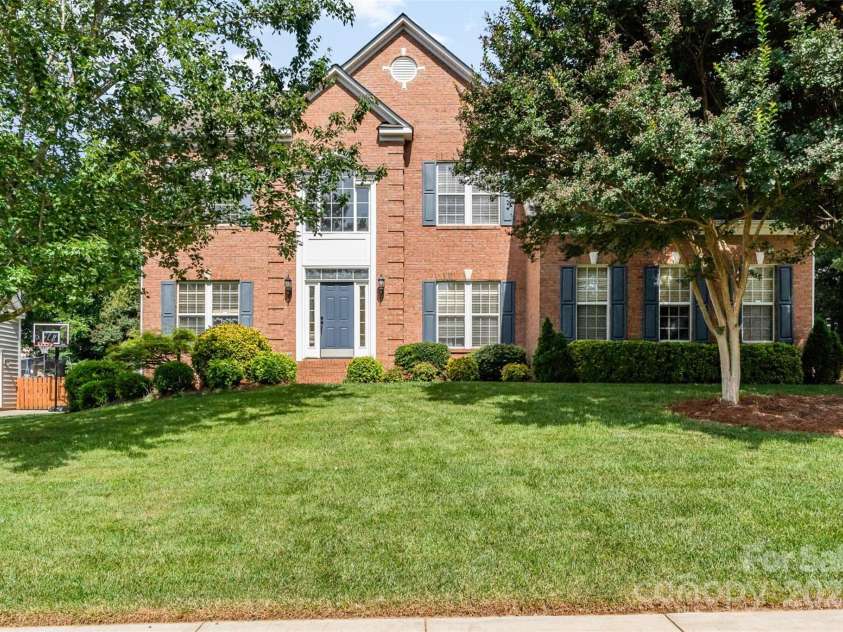 1002 Hollyhedge Lane, Indian Trail, NC 28079.  MLS# CAR4269454, YatesRealty ID 21244. Front view of house with mature trees